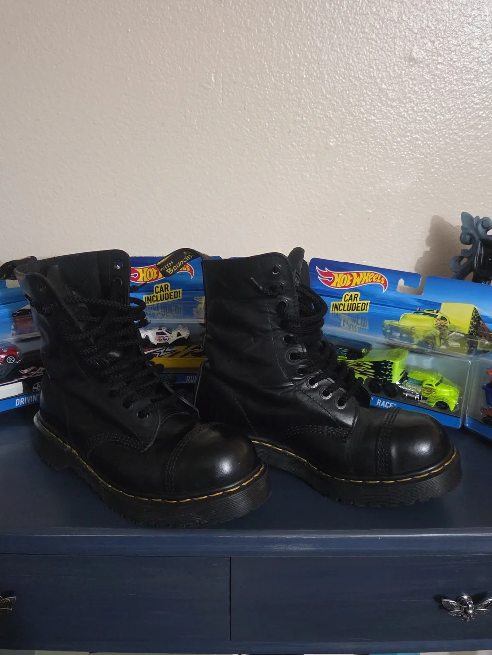 Dr. Martens steel toe black leather lace-up combat boots.